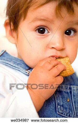 Stock Photo - boy, baby, black hair, biting, bite, 3-4 years. Fotosearch