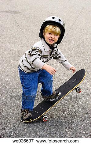 Boy balancing on skateboard View Large Photo Image Stock Photo - Boy balancing on skateboard. Fotosearch