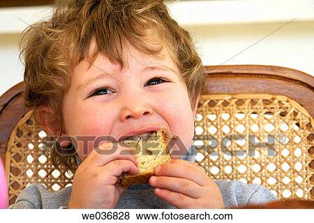 Boy eating a peanut butter sandwich View Large Photo Image Stock Photo - Boy eating a peanut butter sandwich. Fotosearch