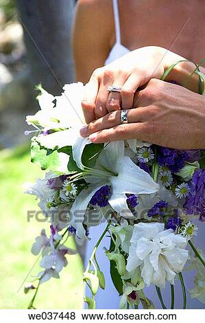 Bride and groom's hands on bouquet View Large Photo Image Stock Photo - Bride and groom's hands on bouquet. Fotosearch