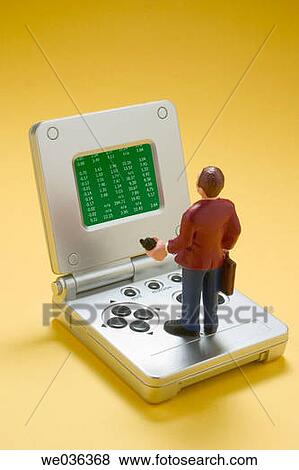 Businessman figure on game machine with stock data View Large Photo Image Stock Photo - Businessman figure on game machine with stock data. Fotosearch