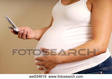 Stock Photo - cell phone, Facial expression, contemporary, communication, anonymous. Fotosearch
