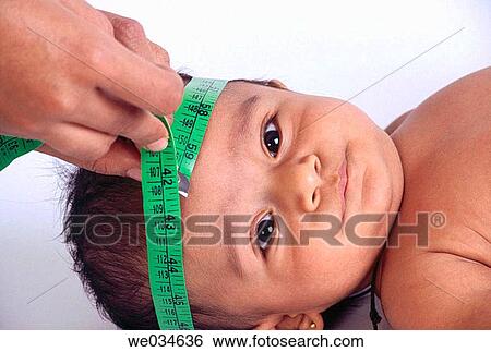 Stock Photograph - Childs head being measured.. Fotosearch