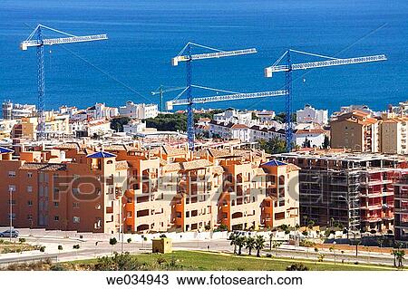 Construction cranes above new apartment blocks. Benalmadena-Costa, Costa del Sol, Malaga Province, Spain View Large Photo Image Stock Image - Construction cranes above new apartment blocks. Benalmadena-Costa, Costa del Sol, Malaga Province, Spain. Fotosearch