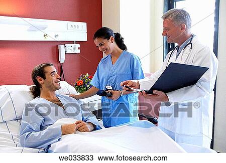 Doctors and patient in hospitalization View Large Photo Image Stock Image - Doctors and patient in hospitalization. Fotosearch