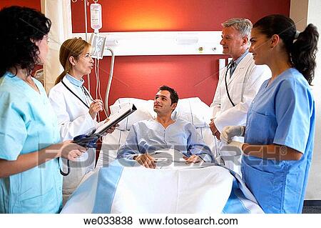 Doctors and patient in hospitalization View Large Photo Image Stock Photo - Doctors and patient in hospitalization. Fotosearch