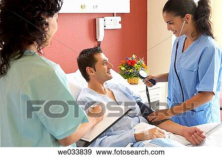 Stock Photo - Doctors and patient in hospitalization. Fotosearch