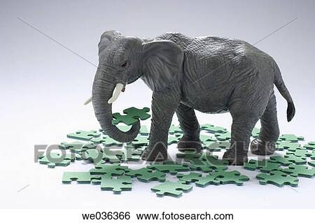 Elephant figurine and puzzle pieces View Large Photo Image Stock Photograph - Elephant figurine and puzzle pieces. Fotosearch
