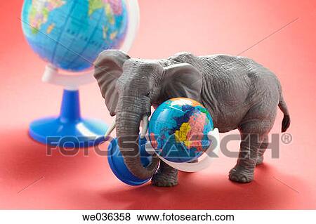 Elephant figurine carrying globe View Large Photo Image Stock Photo - Elephant figurine carrying globe. Fotosearch