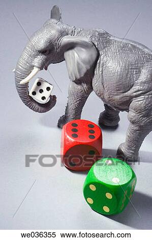 Elephant figurine holding dice View Large Photo Image Stock Photography - Elephant figurine holding dice. Fotosearch