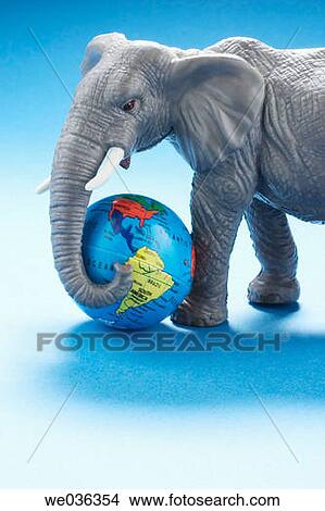 Elephant figurine holding globe View Large Photo Image Picture - Elephant figurine holding globe. Fotosearch