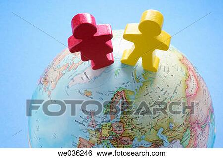 Figures and globe View Large Photo Image Stock Photograph - Figures and globe. Fotosearch