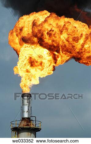 Stock Image - Intense hot fires burning from oil refinery flares.. Fotosearch