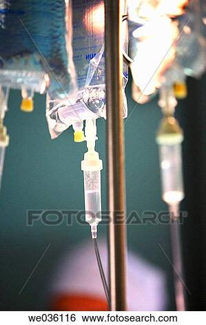 Intravenous bags hanging from intravenous stand View Large Photo Image Stock Photograph - Intravenous bags hanging from intravenous stand. Fotosearch