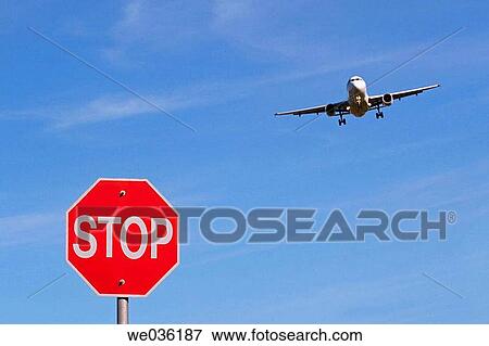 Landing airplane and a Stop sign. Vancouver, Canada View Large Photo Image Stock Photo - Landing airplane and a Stop sign. Vancouver, Canada. Fotosearch