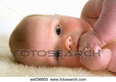 Little boy laying down with fingers in his mouth View Large Photo Image Stock Photography - Little boy laying down with fingers in his mouth. Fotosearch