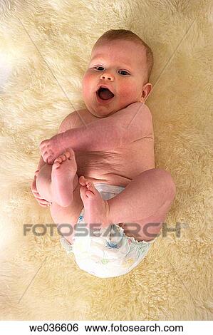 Little boy laying with his legs in the air View Large Photo Image Stock Photograph - Little boy laying with his legs in the air. Fotosearch