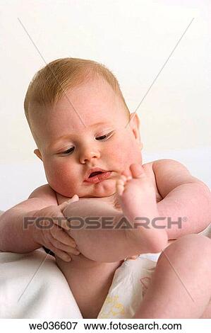 Little boy looking at his leg View Large Photo Image Stock Photo - Little boy looking at his leg. Fotosearch