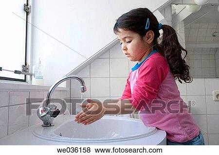 Stock Photo - Little girl is washing her hands. Fotosearch