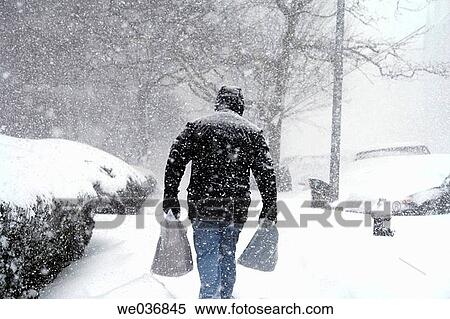 Man carrying grocery packages in a snow storm in Manhattan View Large Photo Image Stock Photography - Man carrying grocery packages in a snow storm in Manhattan. Fotosearch