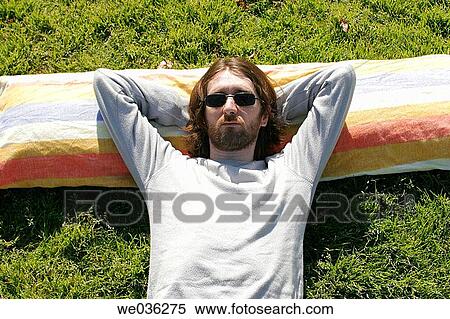 Man laying on grass View Large Photo Image Stock Photography - Man laying on grass. Fotosearch