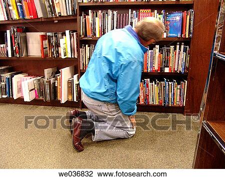 Man looking for a book in a bookstore View Large Photo Image Stock Image - Man looking for a book in a bookstore. Fotosearch