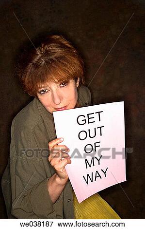 Middle-age woman holding up a sign reading? GET OUT OF MY WAY? View Large Photo Image Stock Photo - Middle-age woman holding up a sign reading? GET OUT OF MY WAY?. Fotosearch