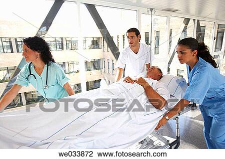 Nurses carrying patient View Large Photo Image Stock Image - Nurses carrying patient. Fotosearch