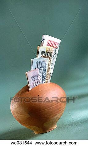 Piggybank with Indian currency notes. View Large Photo Image Picture - Piggybank with Indian currency notes.. Fotosearch
