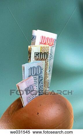 Stock Photography - Piggybank with Indian currency notes.. Fotosearch