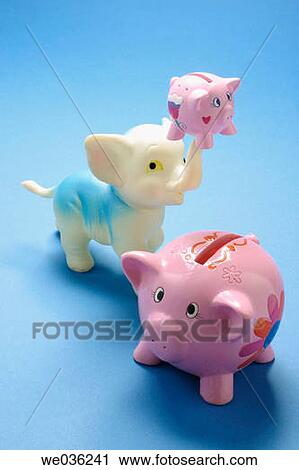 Stock Image - Piggybanks and toy elephant. Fotosearch