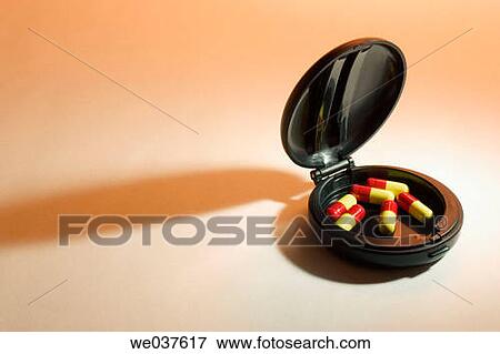 Stock Photo - Pills in compact case. Fotosearch