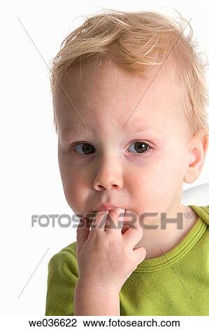 Portrait of a toddler with his finger in this mouth View Large Photo Image Stock Image - Portrait of a toddler with his finger in this mouth. Fotosearch