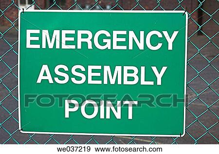 Sign on fence indicating location of emergency assembly point. View Large Photo Image Stock Photo - Sign on fence indicating location of emergency assembly point.. Fotosearch