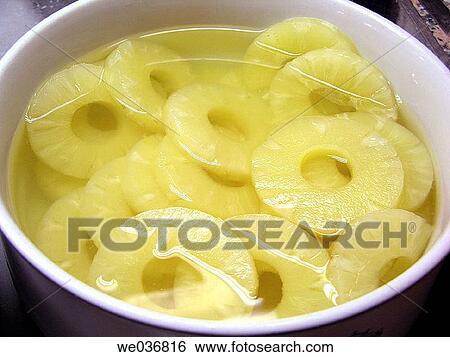 Stock Photograph - Sliced pineapple in syrup. Fotosearch