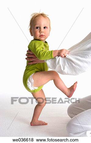 Stock Photo - Toddler climbing at his mothers knees. Fotosearch