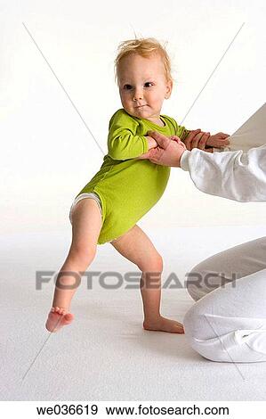 Stock Photo - Toddler pulling his mothers hands. Fotosearch