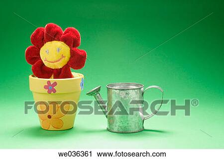 Toy flower and miniature watering can View Large Photo Image Stock Image - Toy flower and miniature watering can. Fotosearch