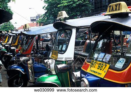 Tuk-Tuk Taxis waiting for customers at the road side, Bangkok, Thailand, Asia View Large Photo Image Stock Photo - Tuk-Tuk Taxis waiting for customers at the road side, Bangkok, Thailand, Asia. Fotosearch