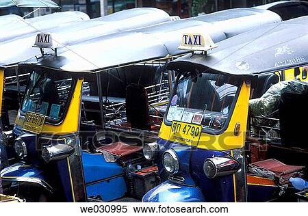 Tuk-Tuk Taxis waiting for customers at the road side, Bangkok, Thailand, Asia View Large Photo Image Stock Photography - Tuk-Tuk Taxis waiting for customers at the road side, Bangkok, Thailand, Asia. Fotosearch