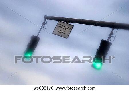 Twin traffic lights, on green, hanging over a city street View Large Photo Image Stock Image - Twin traffic lights, on green, hanging over a city street. Fotosearch
