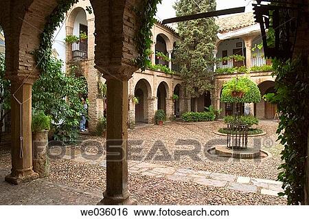 Typical courtyard in the Jewish quarter of C? rdoba. Andalusia, Spain View Large Photo Image Stock Photograph - Typical courtyard in the Jewish quarter of C? rdoba. Andalusia, Spain. Fotosearch