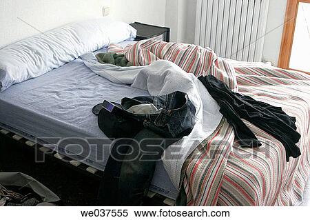 Unmade bed with clothes all over. View Large Photo Image Stock Photography - Unmade bed with clothes all over.. Fotosearch