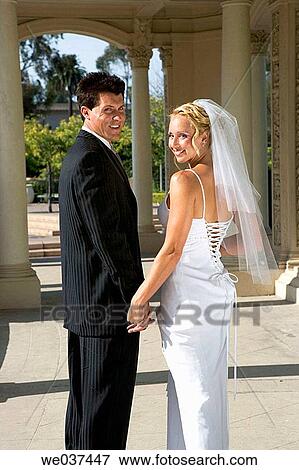 Wedding couple turn around to smile View Large Photo Image Stock Photo - Wedding couple turn around to smile. Fotosearch