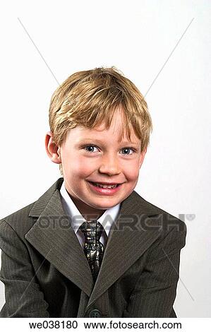 Young blond boy, wearing a suit, posing for the camera View Large Photo Image Stock Image - Young blond boy, wearing a suit, posing for the camera. Fotosearch