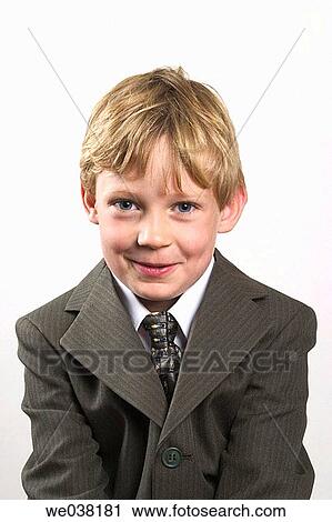 Young blond boy, wearing a suit, posing for the camera View Large Photo Image Stock Image - Young blond boy, wearing a suit, posing for the camera. Fotosearch