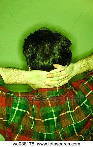 Young man, with his hands on his head, posing with his back to the camera View Large Photo Image Stock Photo - Young man, with his hands on his head, posing with his back to the camera. Fotosearch
