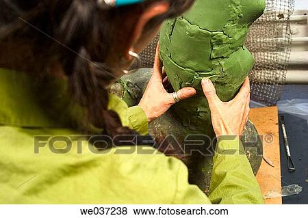 Young woman artist creating a clay sculpture View Large Photo Image Stock Photo - Young woman artist creating a clay sculpture. Fotosearch