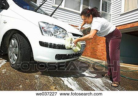 Young woman cleaning her car. View Large Photo Image Stock Photo - Young woman cleaning her car.. Fotosearch