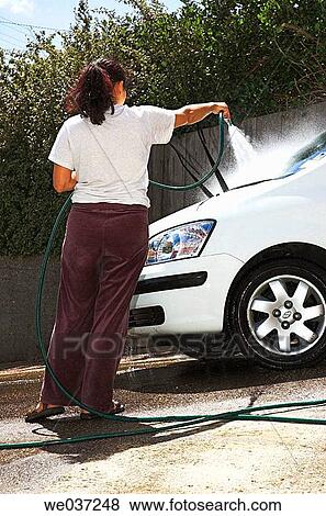 Young woman cleaning her car. View Large Photo Image Stock Photo - Young woman cleaning her car.. Fotosearch